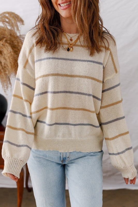 Woman wearing Stripe Ribbed Trim Drop Shoulder Sweater with casual jeans, showcasing trendy striped design and cozy fall style.