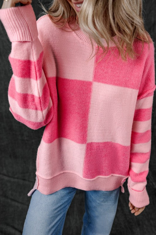 Woman wearing Abigail High Low Loose Sweater, pink colorblocking and striped pattern, high-low hem, casual and feminine fashion.