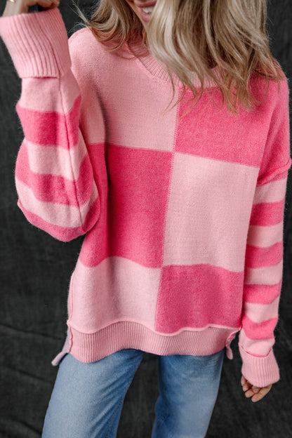 Woman wearing Abigail High Low Loose Sweater, pink colorblocking and striped pattern, high-low hem, casual and feminine fashion.