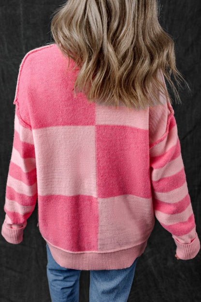 Back view of pink Abigail High Low Loose Sweater with colorblocking and striped pattern, showing modern asymmetric design.