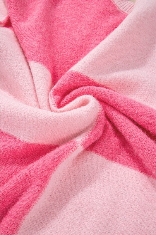 Close-up of pink striped Abigail High Low Loose Sweater showcasing soft fabric and classic colorblocking design.