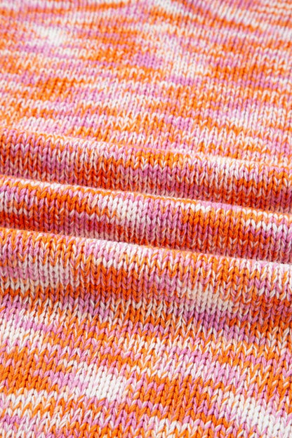 Close-up of vibrant abstract print on Sofia Shoulder Tunic Oversized Sweater fabric, featuring orange, white, and pink knit pattern.