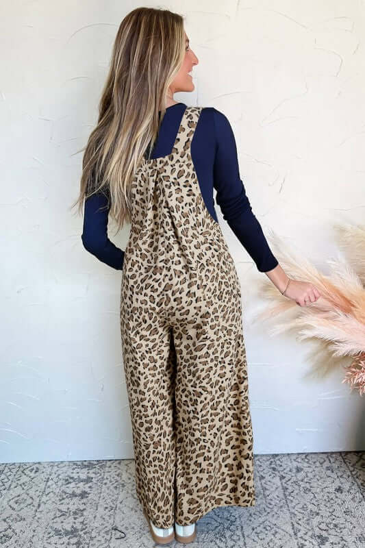 Woman wearing Leopard Bib Wide Leg Jumpsuit, showcasing the trendy print and wide-leg silhouette.