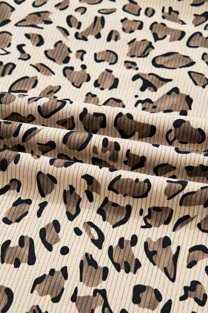 Leopard Bib Wide Leg Jumpsuit fabric close-up with bold leopard print design in earthy tones.