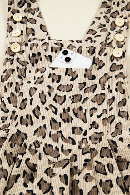 Leopard Bib Wide Leg Jumpsuit detailed view with buttons and pocket for phone, showcasing trendy design.