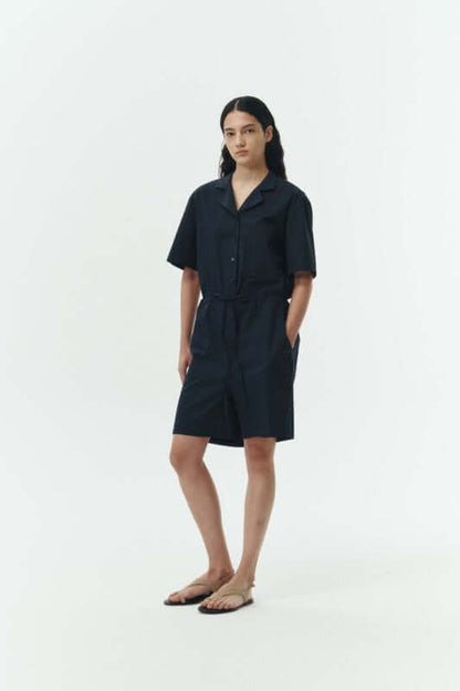 Model wearing the Emma Solid Jumpsuit in dark color, showcasing its lightweight 100% cotton design.