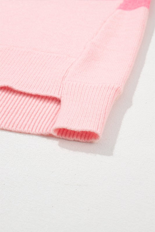 Close-up of pink Abigail High Low Loose Sweater showing knit texture and hem detailing.