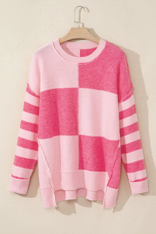 Abigail High Low Loose Sweater in pink with stripes and colorblocking, featuring a modern high-low hem and relaxed fit for everyday style.