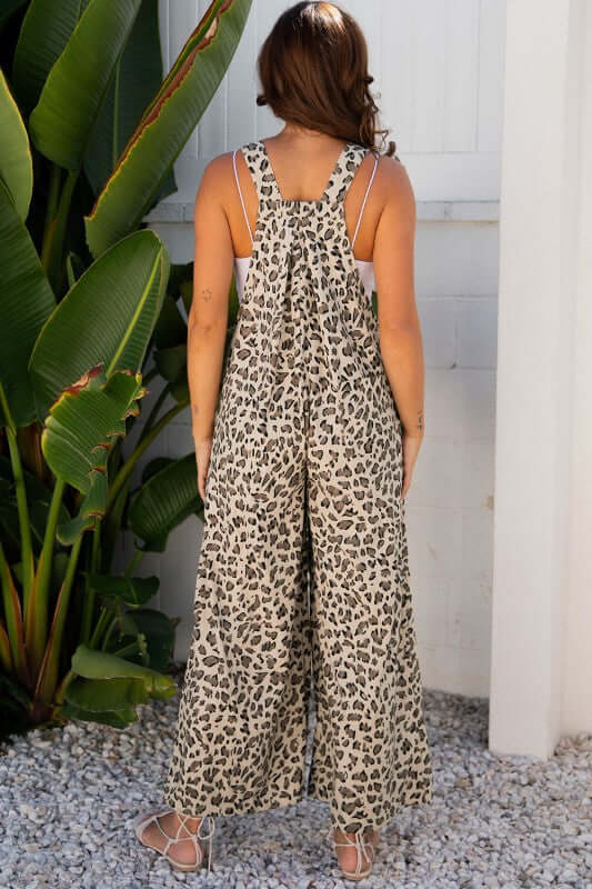 Leopard Bib Wide Leg Jumpsuit showcasing back view with bold leopard print and loose wide-leg silhouette.